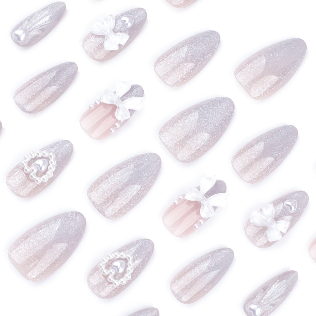 Artful nail decoration with pearl and bow accents Stornfield
