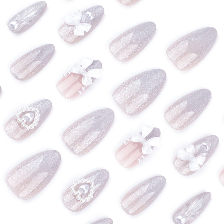 Artful nail decoration with pearl and bow accents Stornfield