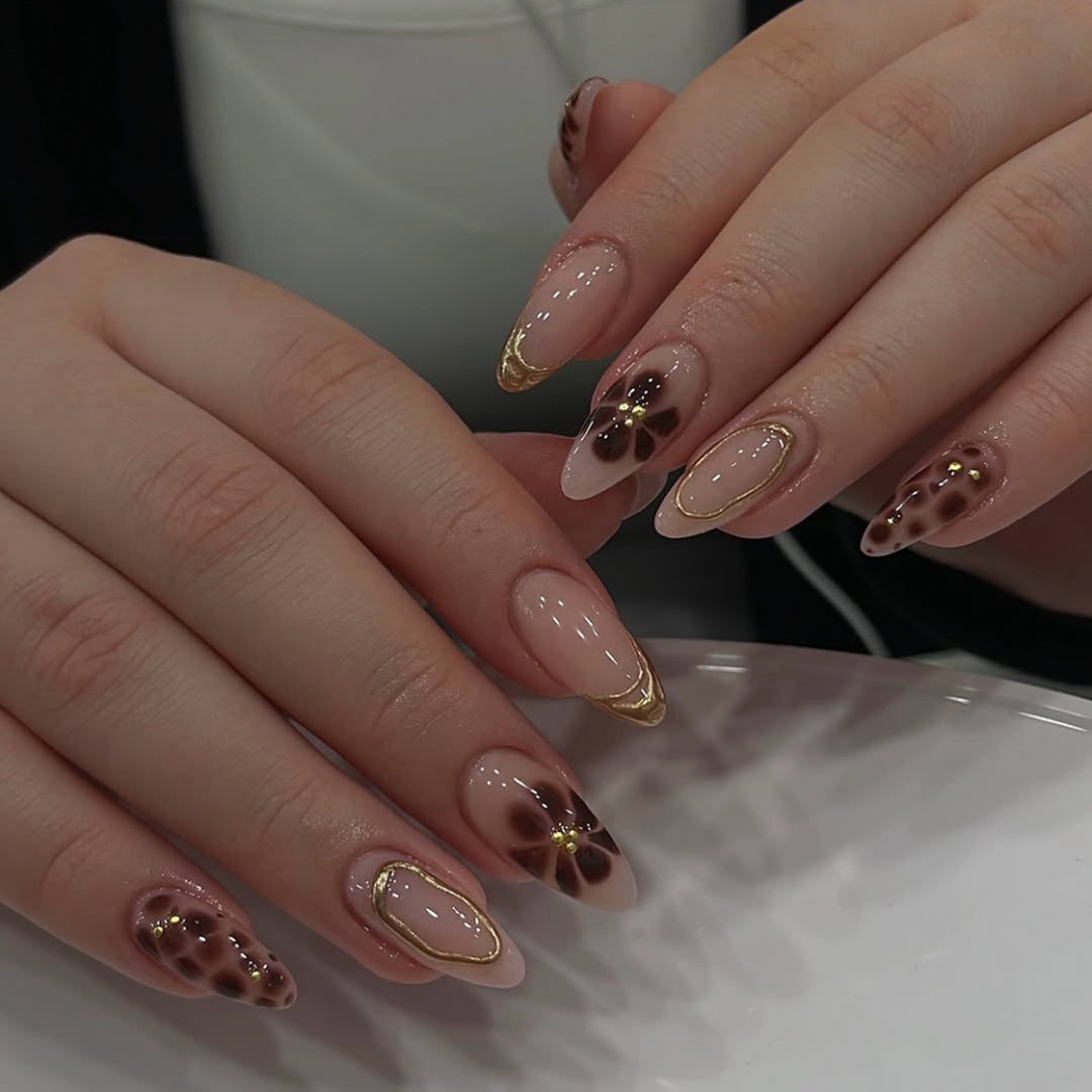 Elegant artificial nails with floral accents and gold details Stornfield