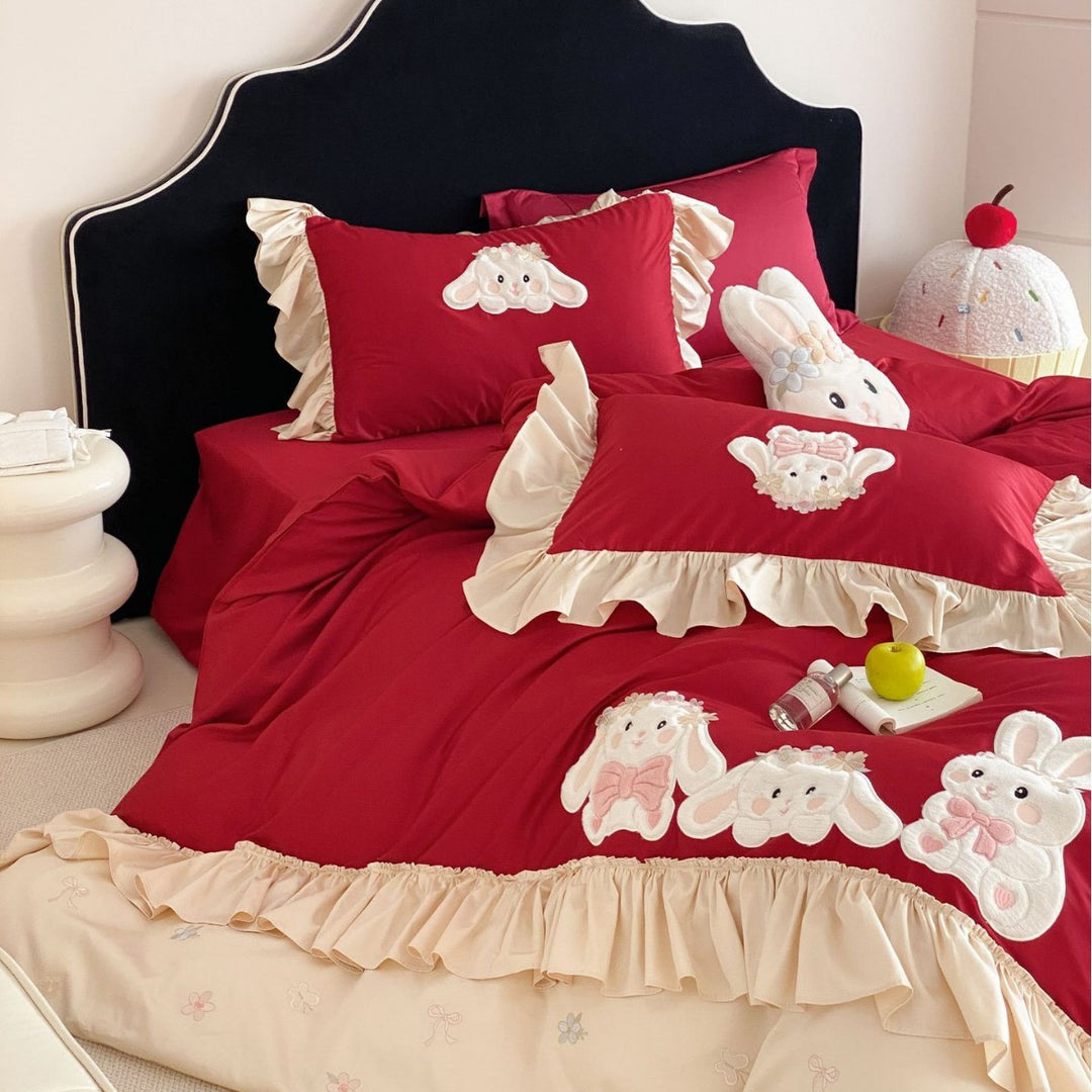 Playful bedding set with ruffles, three-dimensional appliqués, and delicate embroidery