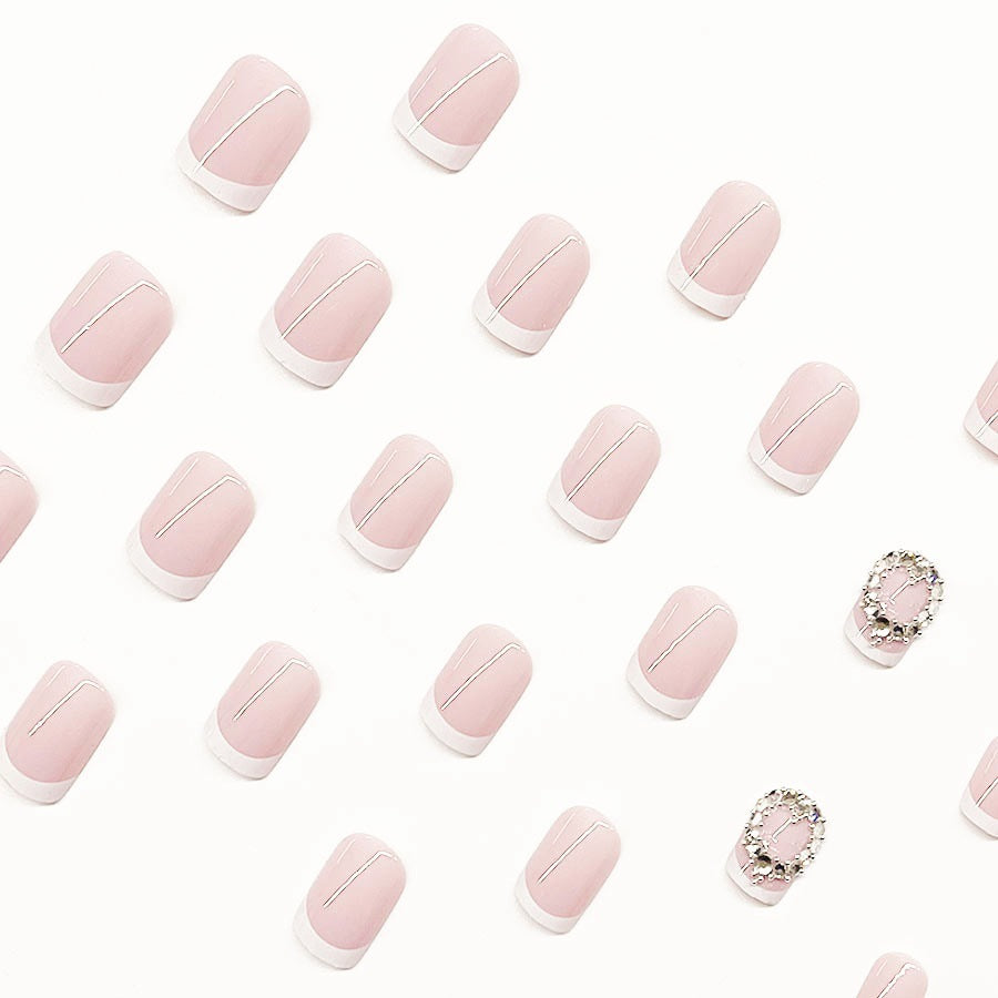 Artificial nail set with elegant French design and rhinestone embellishments Stornfield