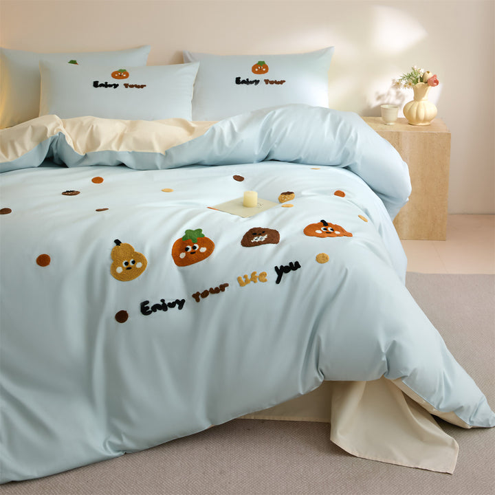 Embroidered bedding set with cute pumpkin appliqués and reversible functionality