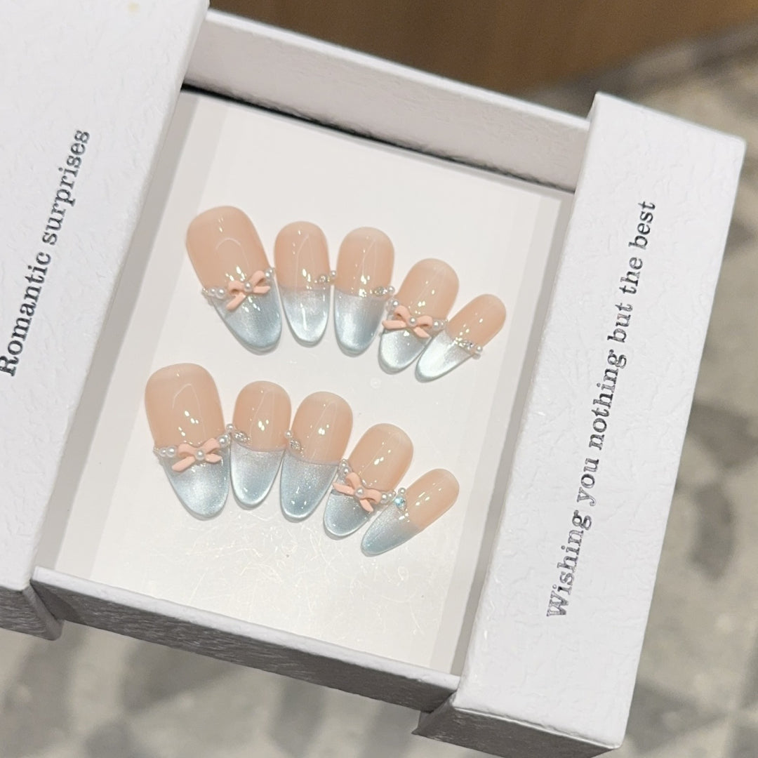 Artificial nail set with romantic bow and glitter accents Stornfield