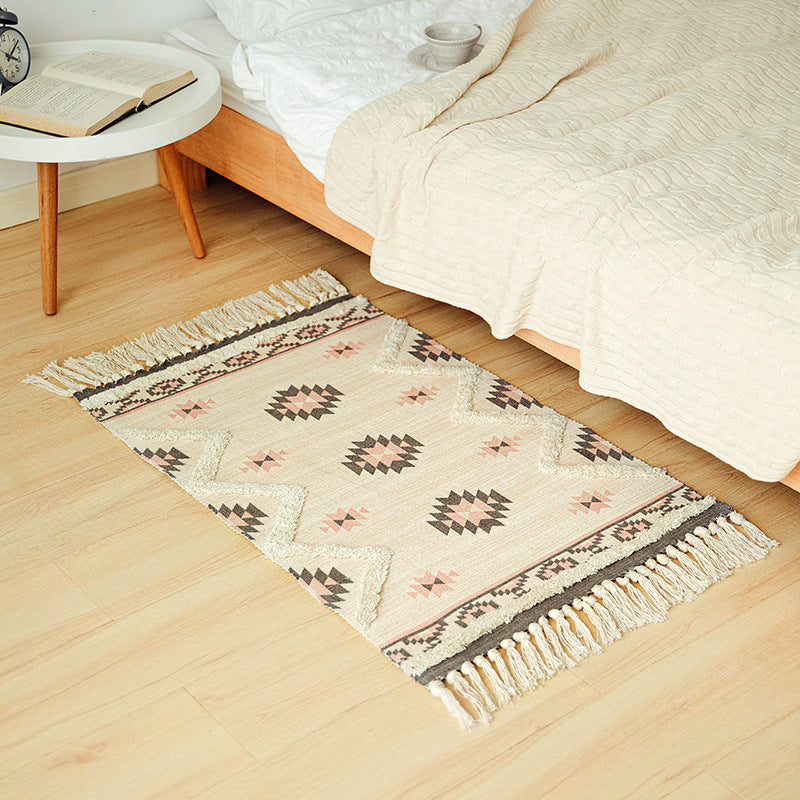 Hand-tufted bathroom mat with fringes, decorative dot-and-dash pattern and non-slip backing Stornfield