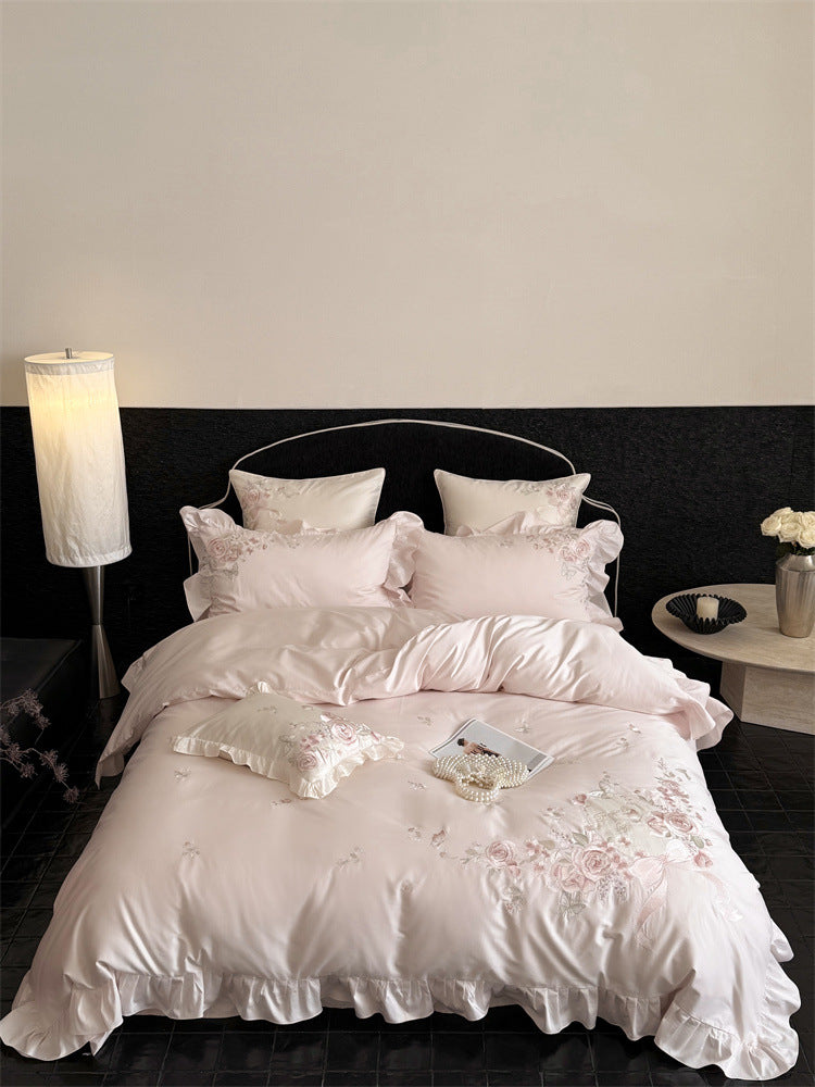 Luxurious satin bedding set with floral embroidery, ruffled edge and silky-matte finish Stornfield