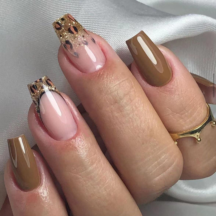 Glamorous acrylic nails with glitter and leopard designs Stornfield