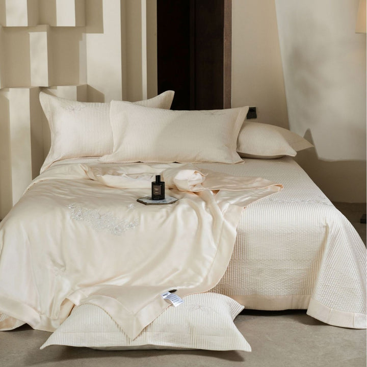 Luxurious cotton satin bedding set with quilted bedspread and floral embroidery