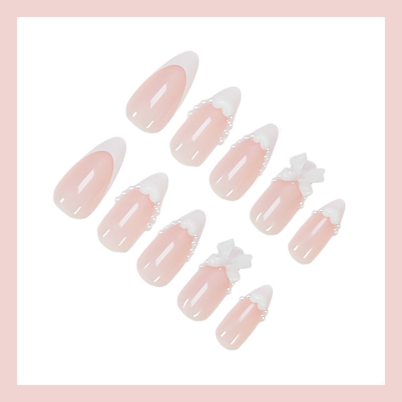 Artificial nail set with elegant tips and playful bow details Stornfield
