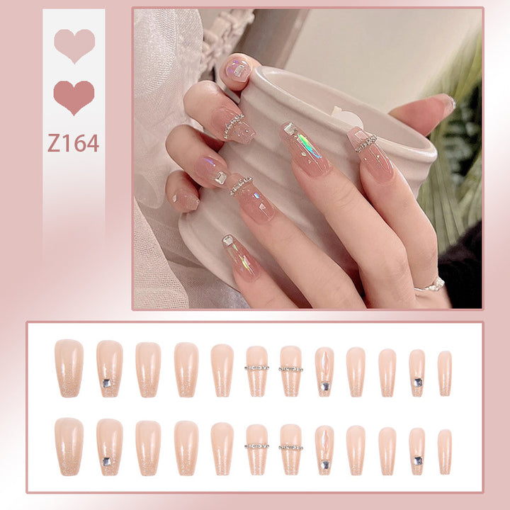 Acrylic nail set with glamorous rhinestone and glitter elements Stornfield