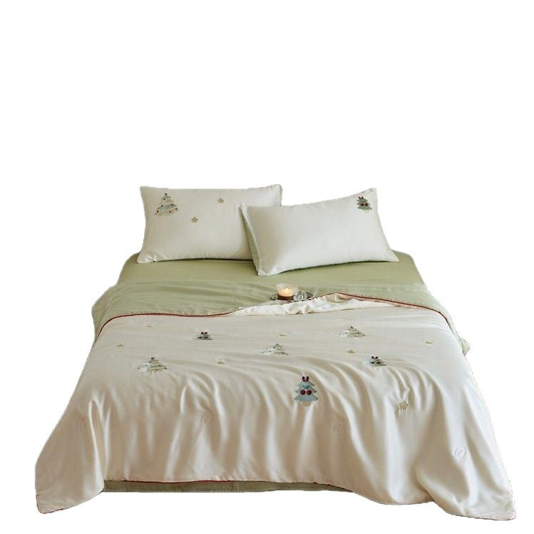 Luxurious satin bed linen set with embroidered Christmas tree motifs and contrasting piping