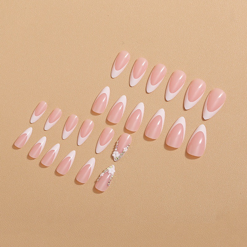 Artificial nails with elegant French tips and rhinestone details Stornfield