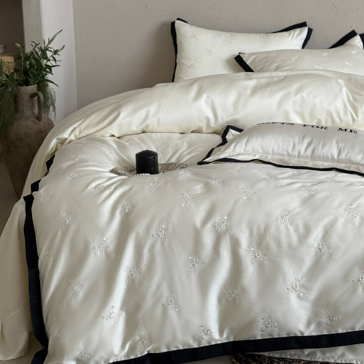 Noble cotton satin bedding set with tone-on-tone floral embroidery and contrasting piping