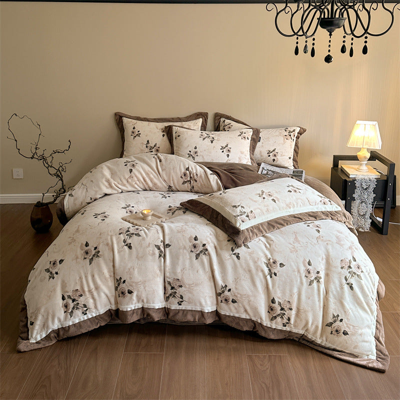Luxurious quilted bedding set with velvet trim and floral branch motif