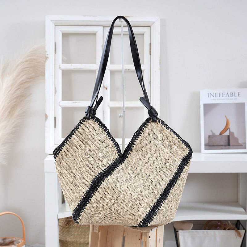 Handbag made of braided natural material with contrasting leather handles Stornfield