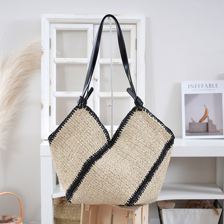Handbag made of braided natural material with contrasting leather handles Stornfield