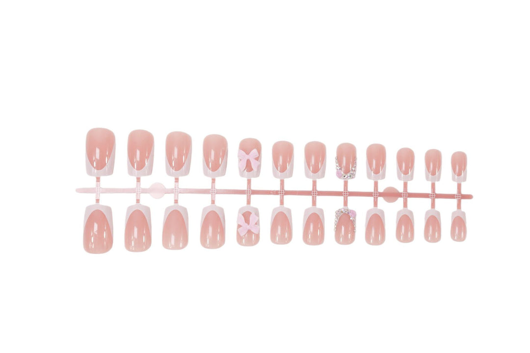 Artificial nail set with elegant bow and glitter designs Stornfield