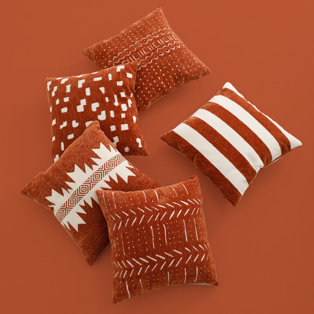Woven cushion cover with graphic ethnic pattern and contrasting borders