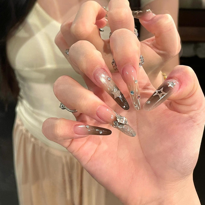 Glamorous artificial nails with sparkling rhinestone and star designs Stornfield