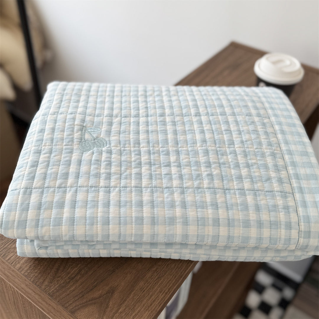 Quilted cotton bedspread with fine striped texture and cherry embroidery