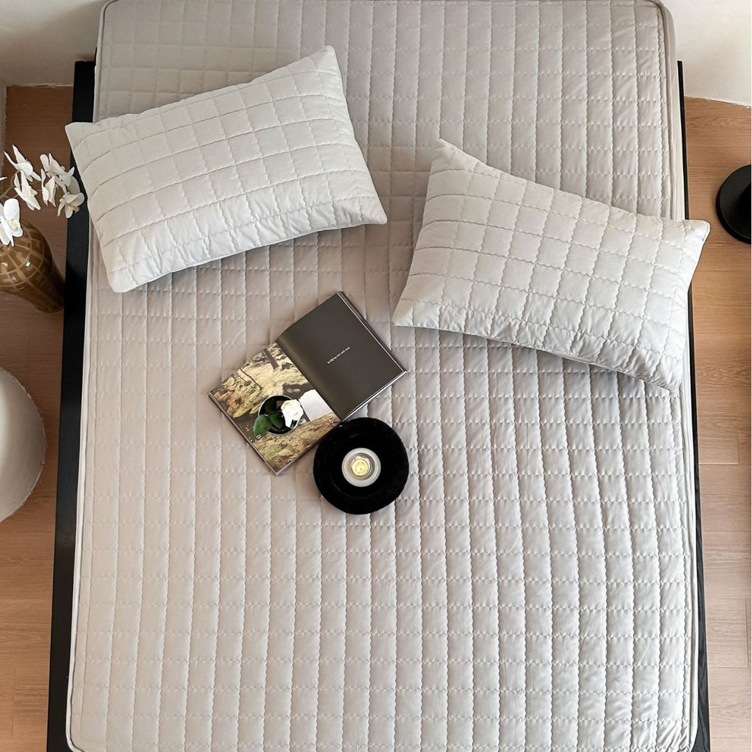 Padded quilted mattress topper with non-slip bottom and breathable fiber filling