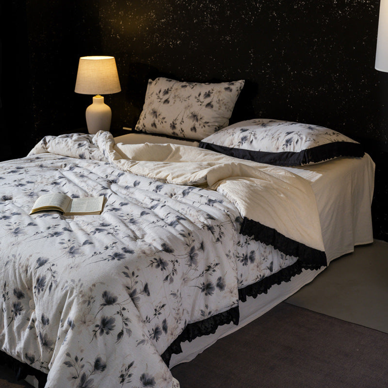 Bedding set made of cotton blend with subtle floral stitching pattern and lace border
