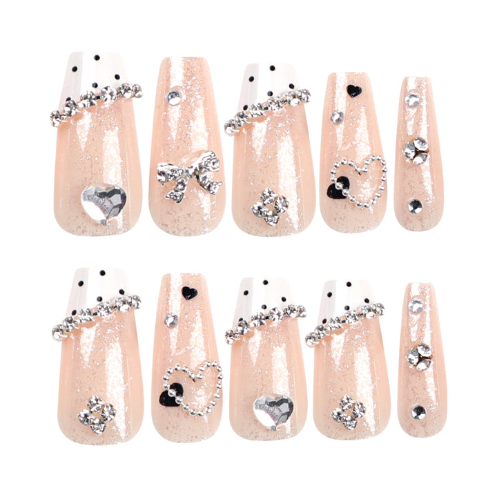 Artful nail extensions with elegant rhinestone and heart designs Stornfield