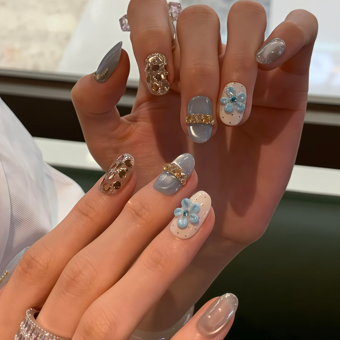 Artificial nails with luxurious glitter details and floral accents Stornfield