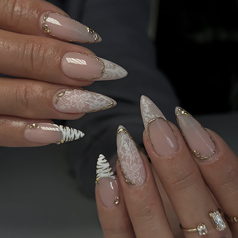 Artful stiletto nails with gold and tip embellishments Stornfield