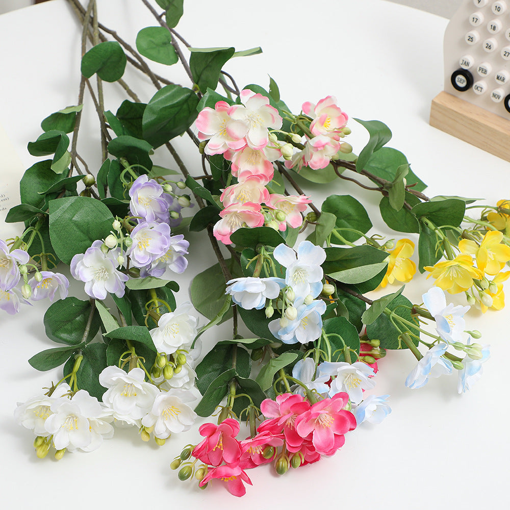 Artificial flower branch with vibrant pink flowers