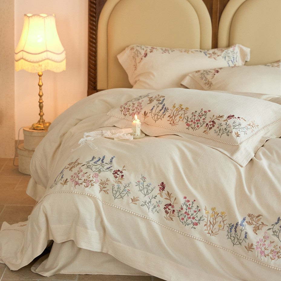 Romantic cotton satin duvet cover set with delicate floral embroidery and decorative pillow
