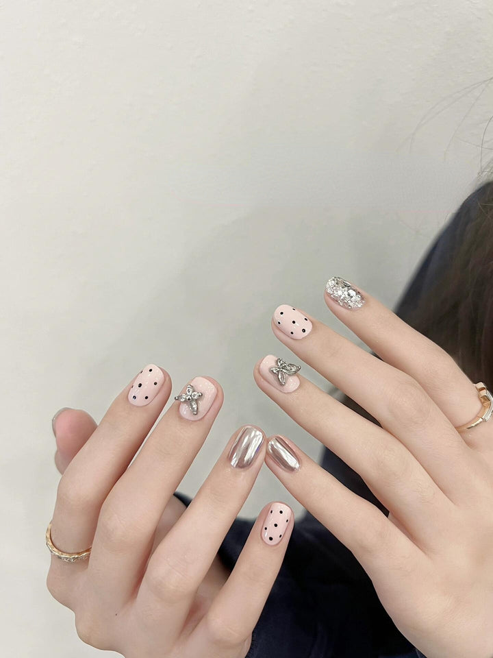 Artificial nails with playful design and glitter accents Stornfield