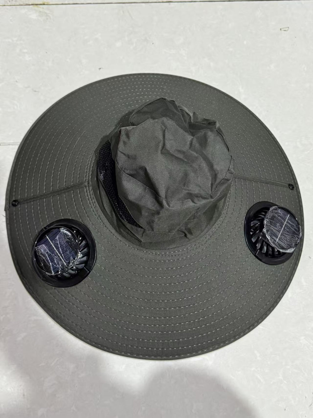 Ventilated sun hat with integrated battery fans, breathable mesh inserts, and adjustable chin strap Stornfield