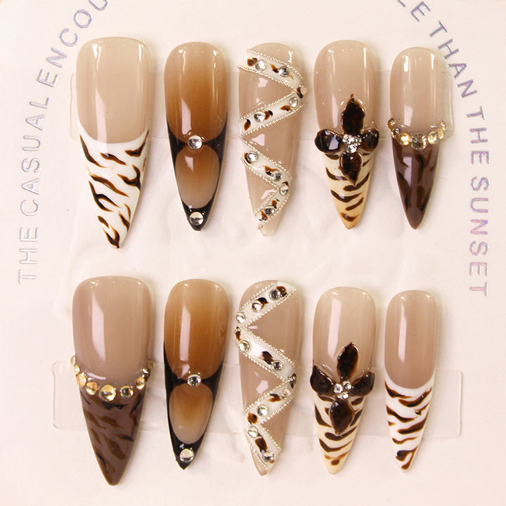 Artificial nails with extravagant designs and glitter accents Stornfield