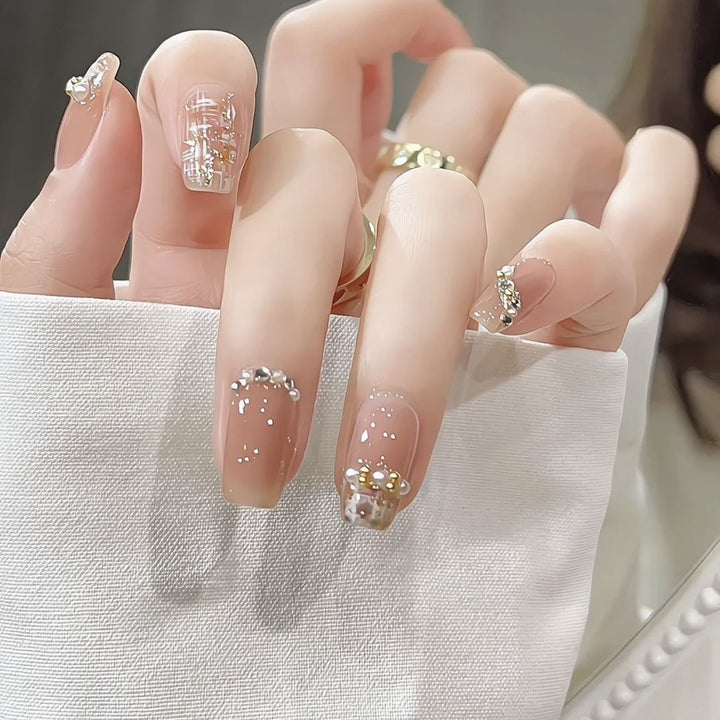 Glamorous artificial nails with striking pearl and glitter elements