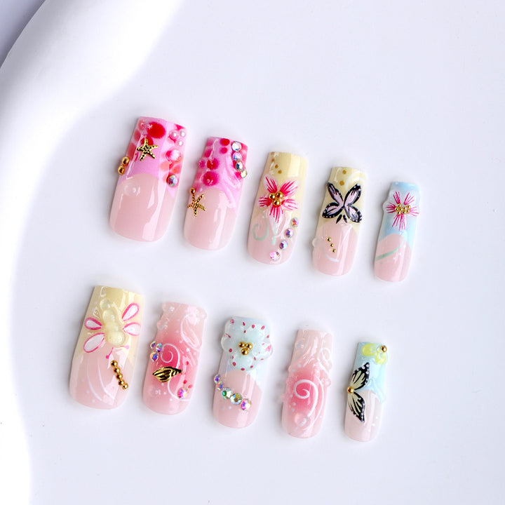 Artistic nails with floral accents and glitter clusters Stornfield