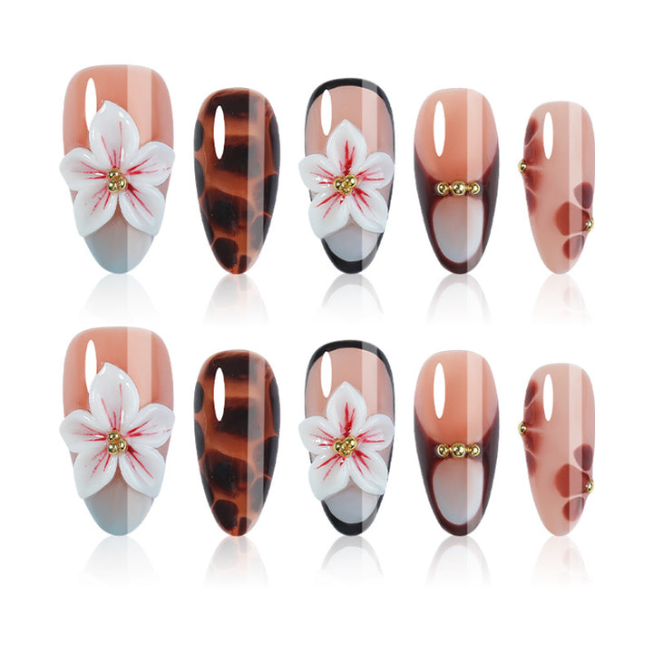 Acrylic nail set with floral accents and elegant embellishments Stornfield