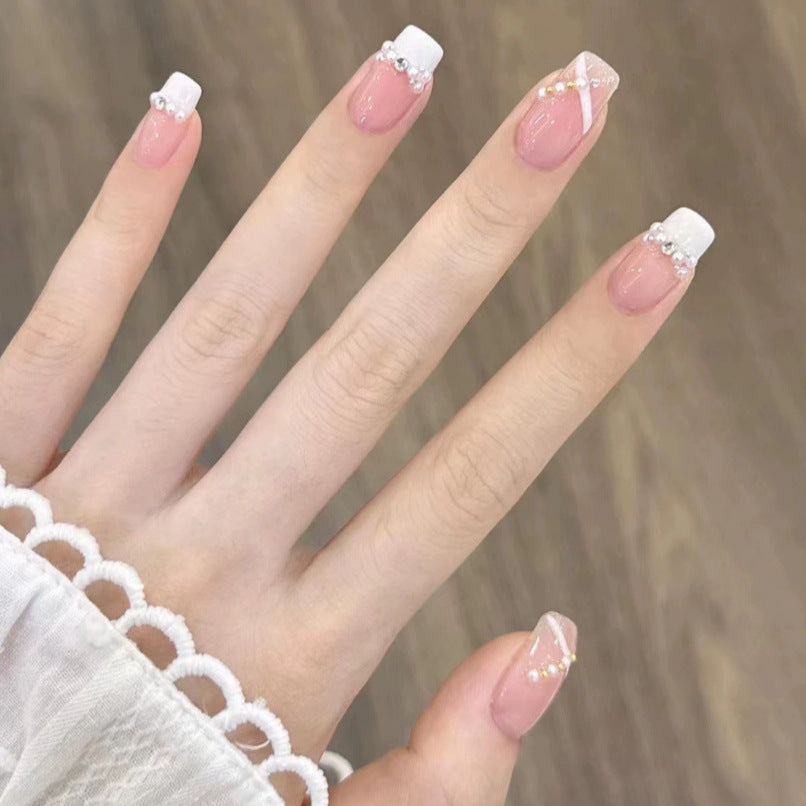 Elegant nail design with pearl embellishment Stornfield