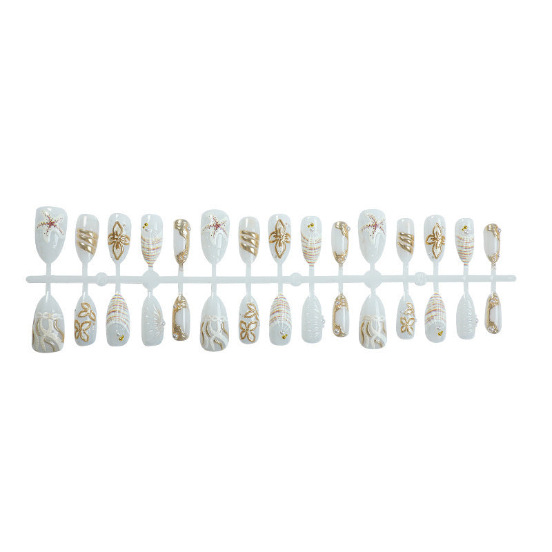 Artificial nail set with luxurious gold embellishments and elegant natural motifs Stornfield