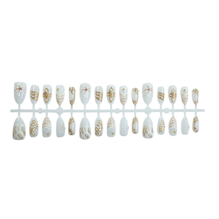 Artificial nail set with luxurious gold embellishments and elegant natural motifs Stornfield