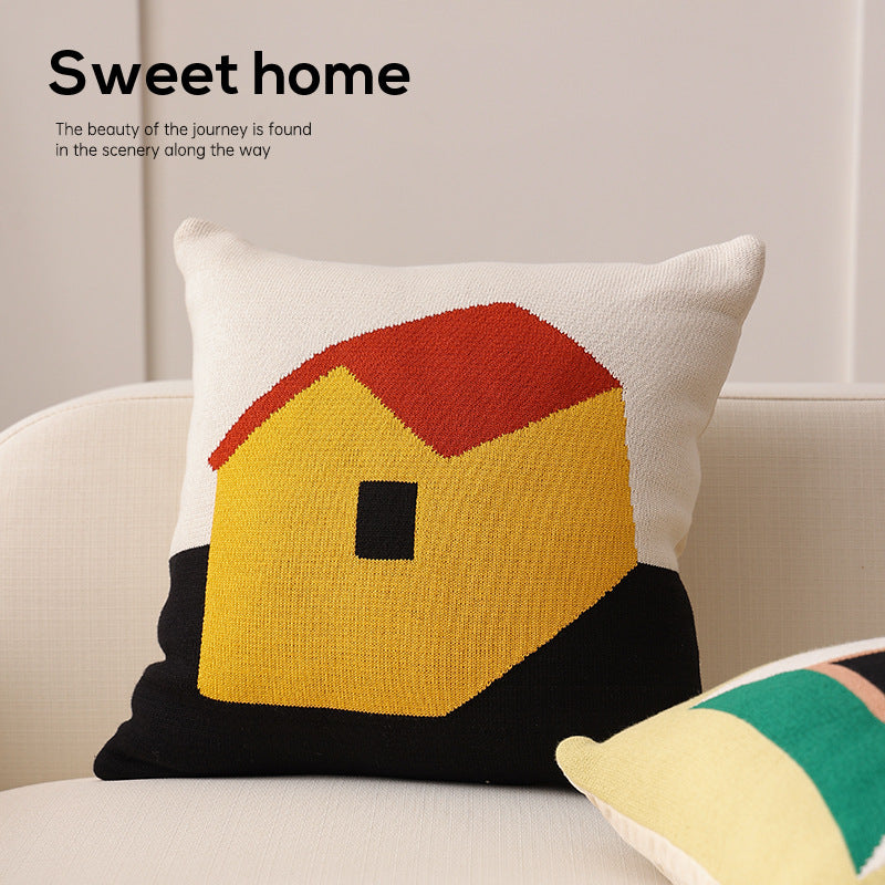Geometric knit pillow with triangle pattern and logo patch