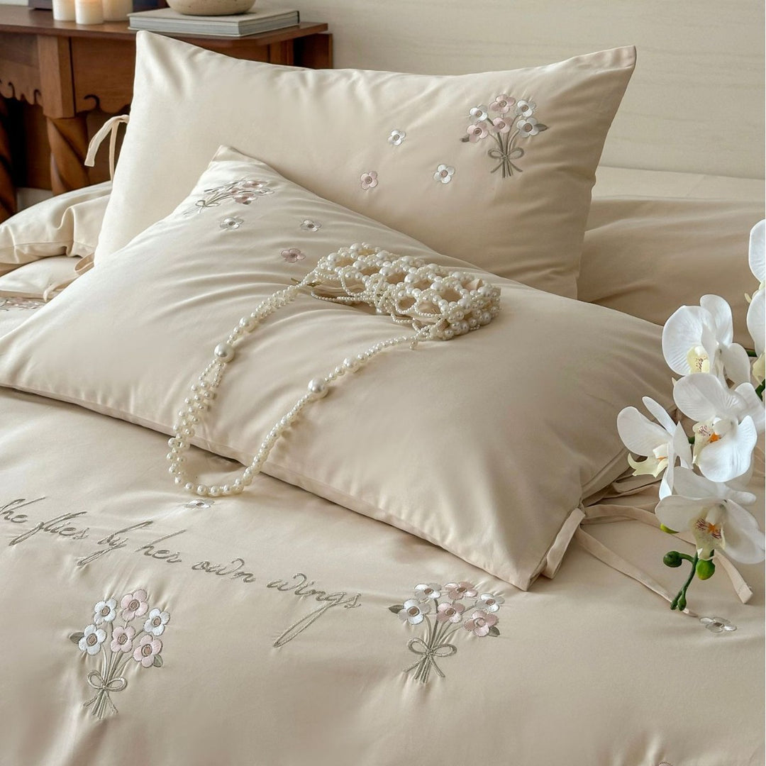 Luxurious satin bedding set with delicate pearl flower embroidery and tie ribbons