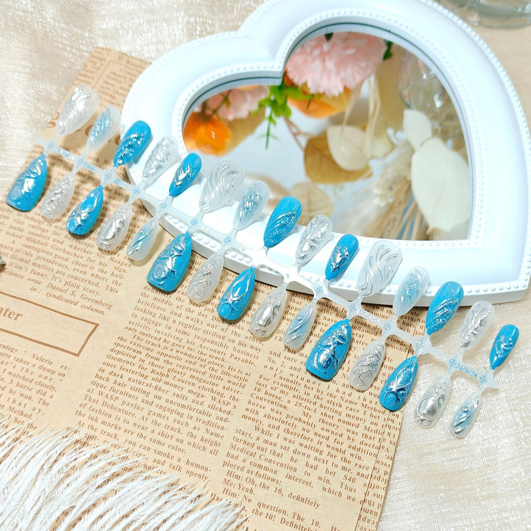 Creative artificial nails with shiny silver and turquoise tones Stornfield