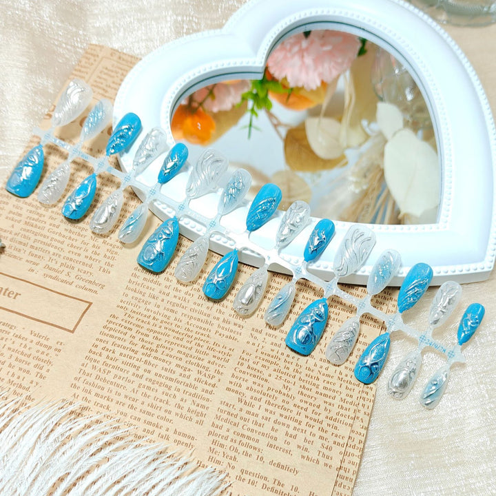Creative artificial nails with shiny silver and turquoise tones Stornfield