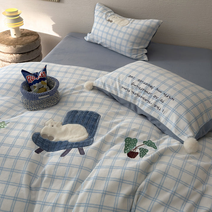Plush bedding set with embroidered dog motif and striped cuddle blanket