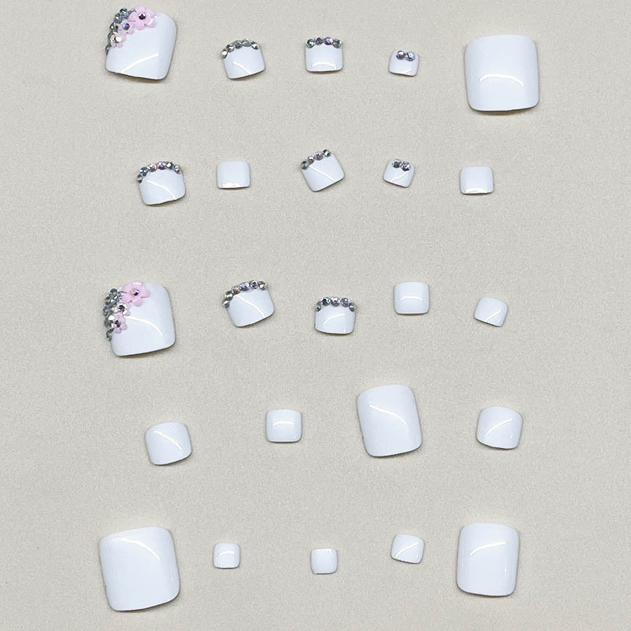 Nail art set with elegant glitter embellishments and floral accents Stornfield