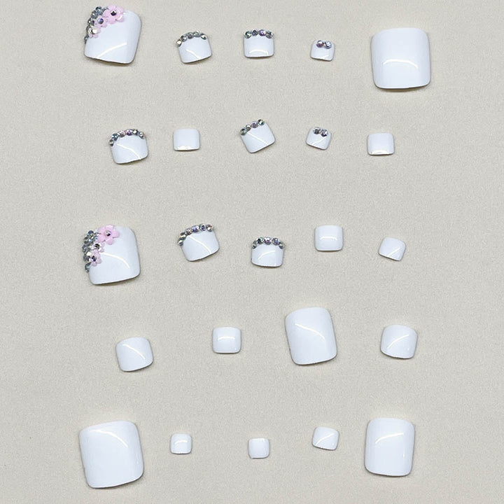Nail art set with elegant glitter embellishments and floral accents Stornfield