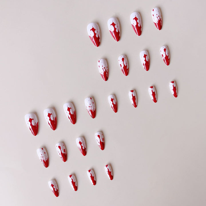 Artificial nail set with blood red inspired design and pointed accents Stornfield