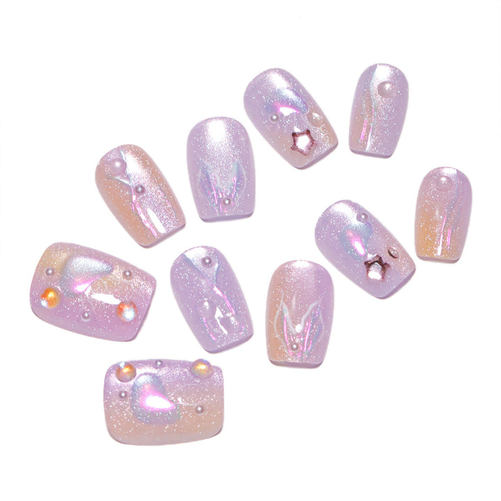 Artificial nail art with sparkling accents and transparent color gradient Stornfield