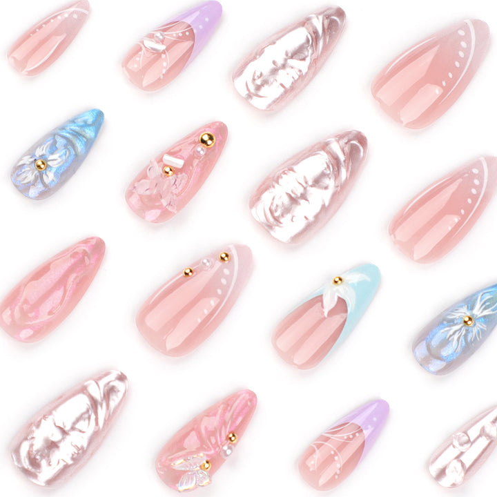 Artistic stiletto nails with delicate flower and glitter embellishments Stornfield