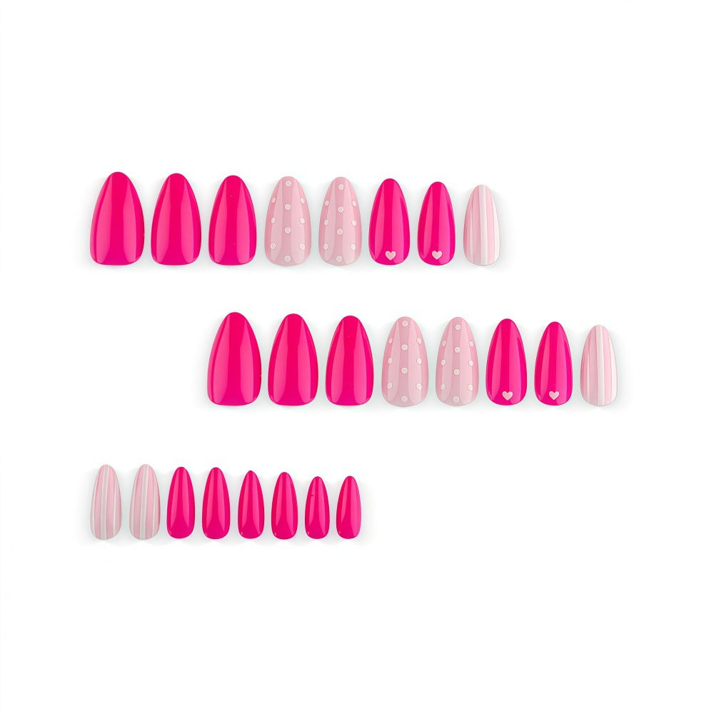 Artificial nails in playful design with hearts and dots Stornfield